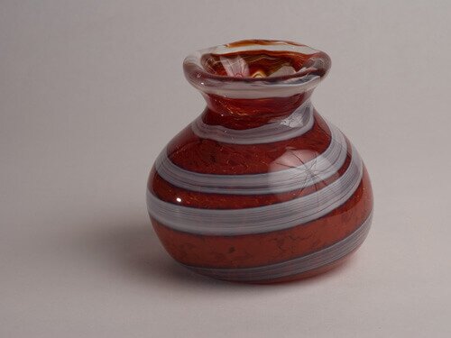 A red and white hand blown glass vase