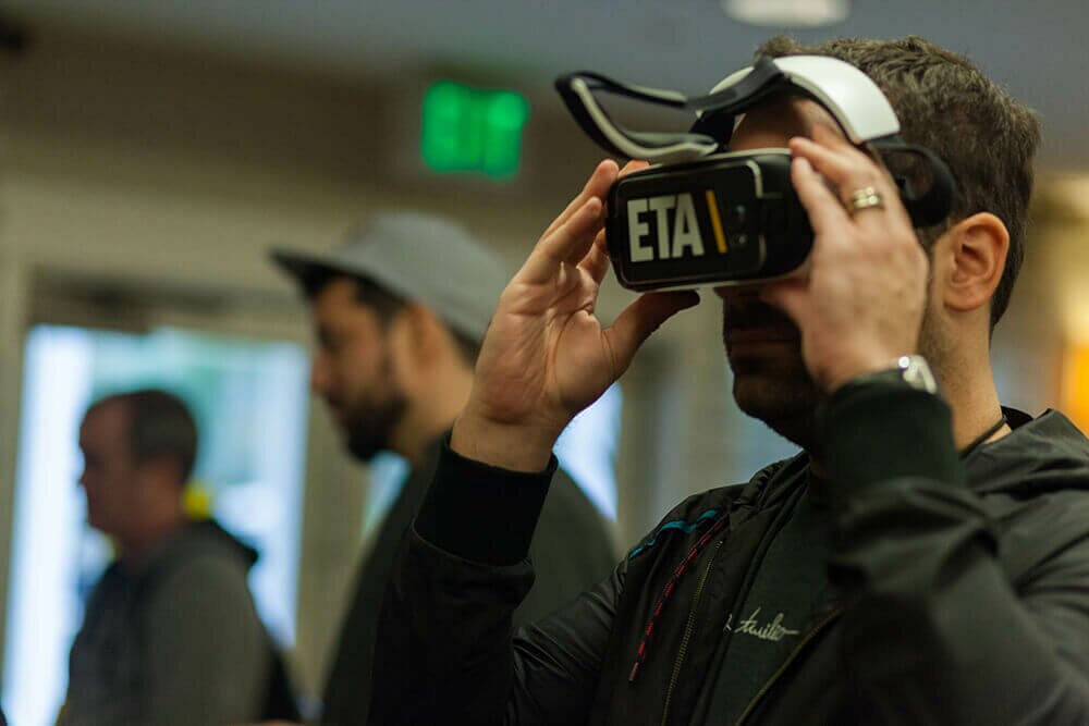 An attendee tests VR goggles at JSConf Last Call